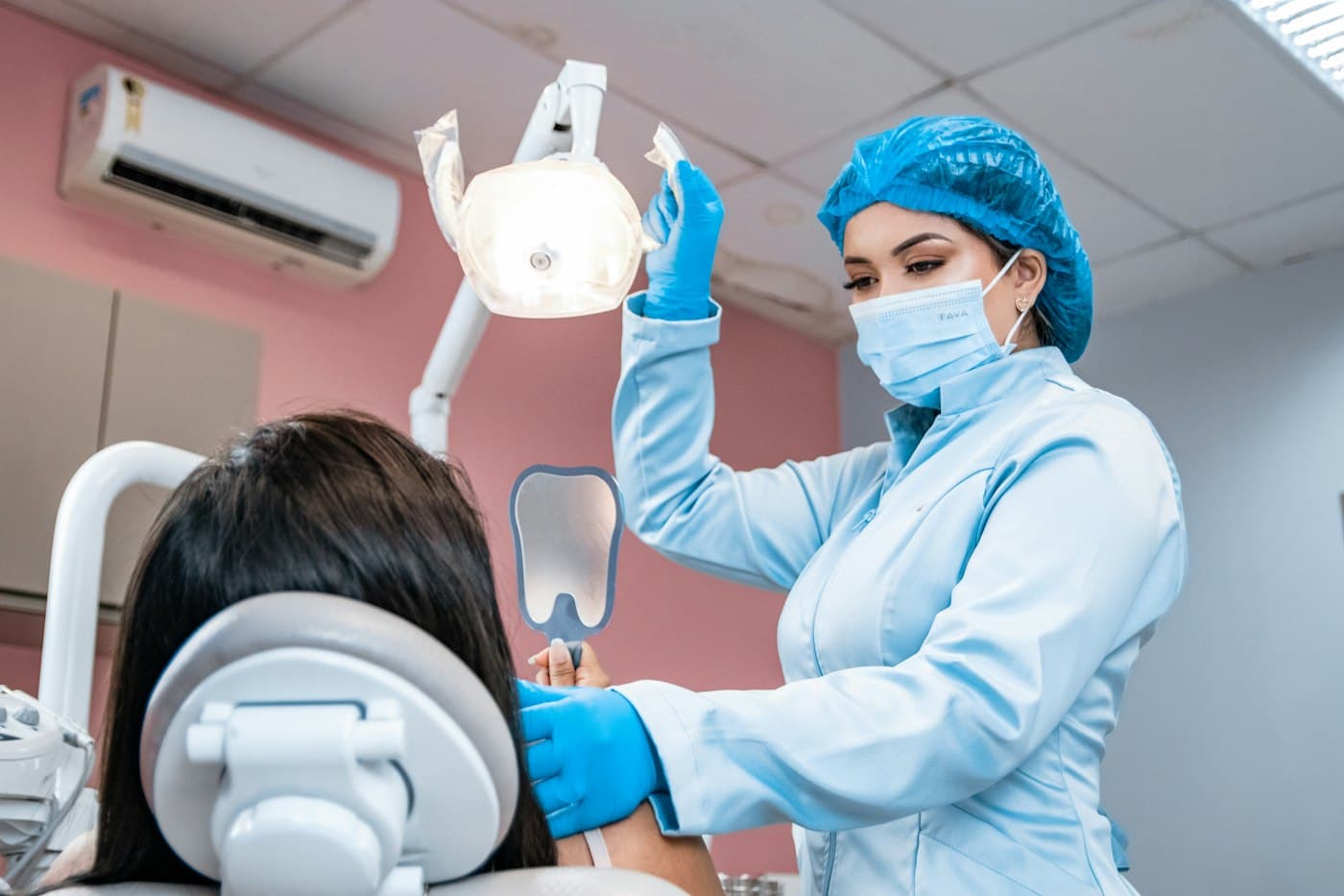 Patient laughing with her dentist in a bright, wood-floored studio